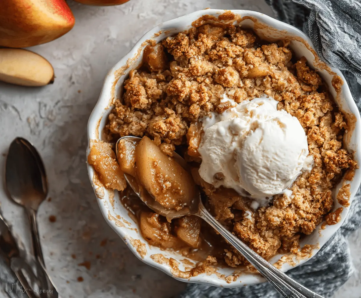 Delicious homemade apple pear crisp topped with golden, crunchy oat streusel in a baking dish, perfect for fall desserts.