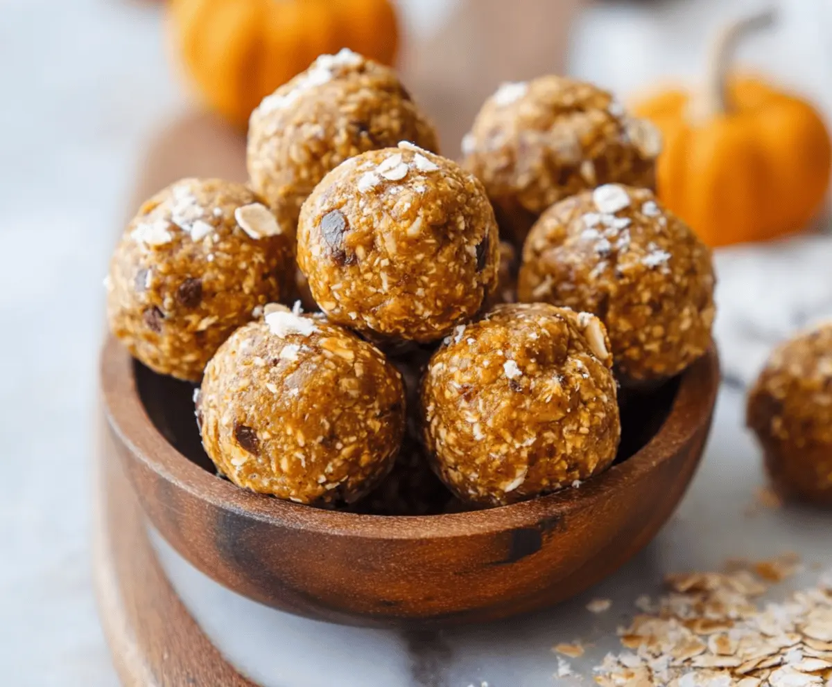 Healthy homemade Pumpkin Protein Balls on a white plate with cinnamon and pumpkin seeds, perfect for a nutritious snack